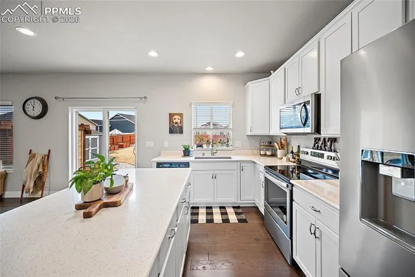 a kitchen with refrigerator and center island