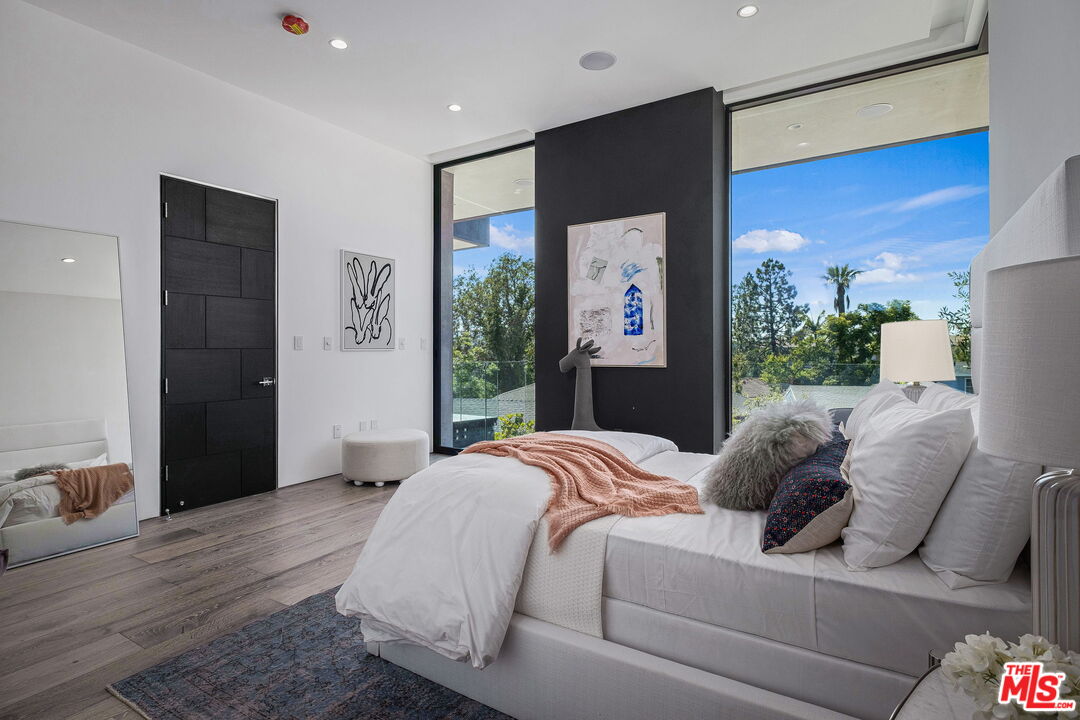 2304 Donella Circle Los Angeles, CA 90077 - Photo 24 of 35 a bedroom with a bed and a flat screen tv