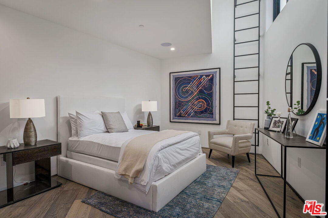 2304 Donella Circle Los Angeles, CA 90077 - Photo 26 of 35 a bedroom with a bed and a flat screen tv