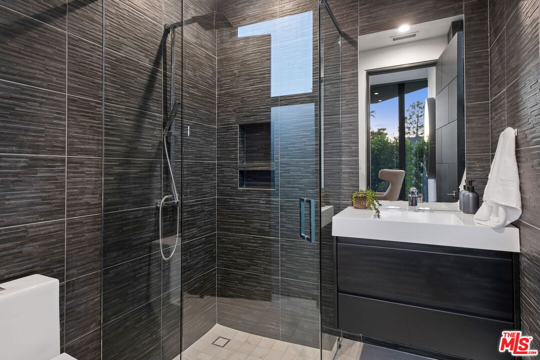 2304 Donella Circle Los Angeles, CA 90077 - Photo 27 of 35 a bathroom with a sink a toilet and shower