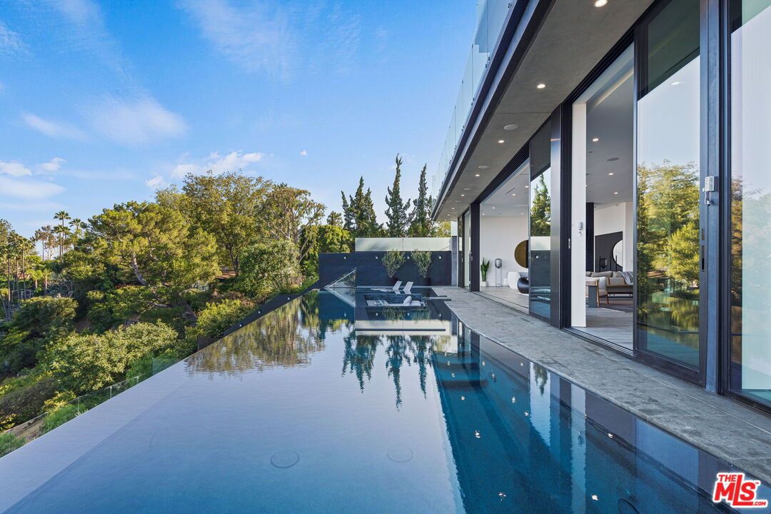 2304 Donella Circle Los Angeles, CA 90077 - Photo 32 of 35 a view of a patio with table and chairs and potted plants