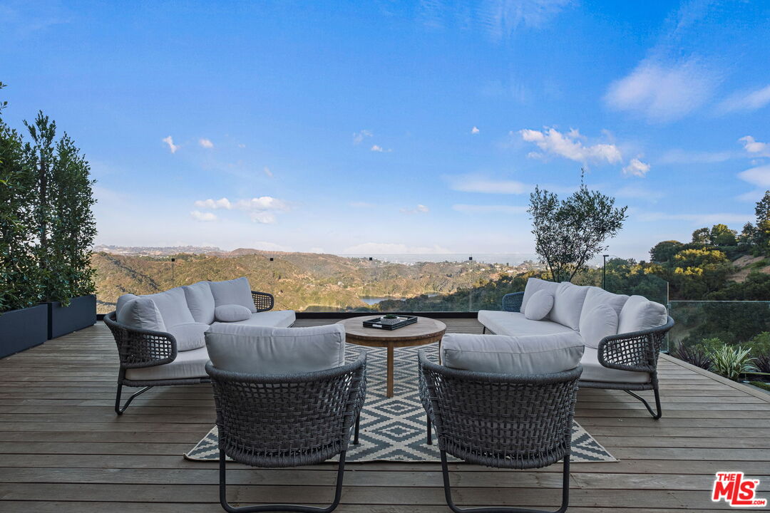 2304 Donella Circle Los Angeles, CA 90077 - Photo 33 of 35 a view of a patio with couches and table and chairs and potted plants