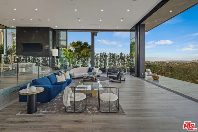 a living room with fireplace furniture and a wooden floor