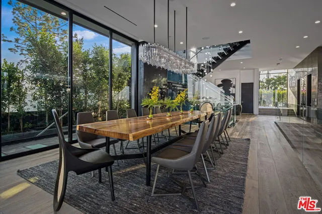 a dining room with furniture a chandelier and wooden floor