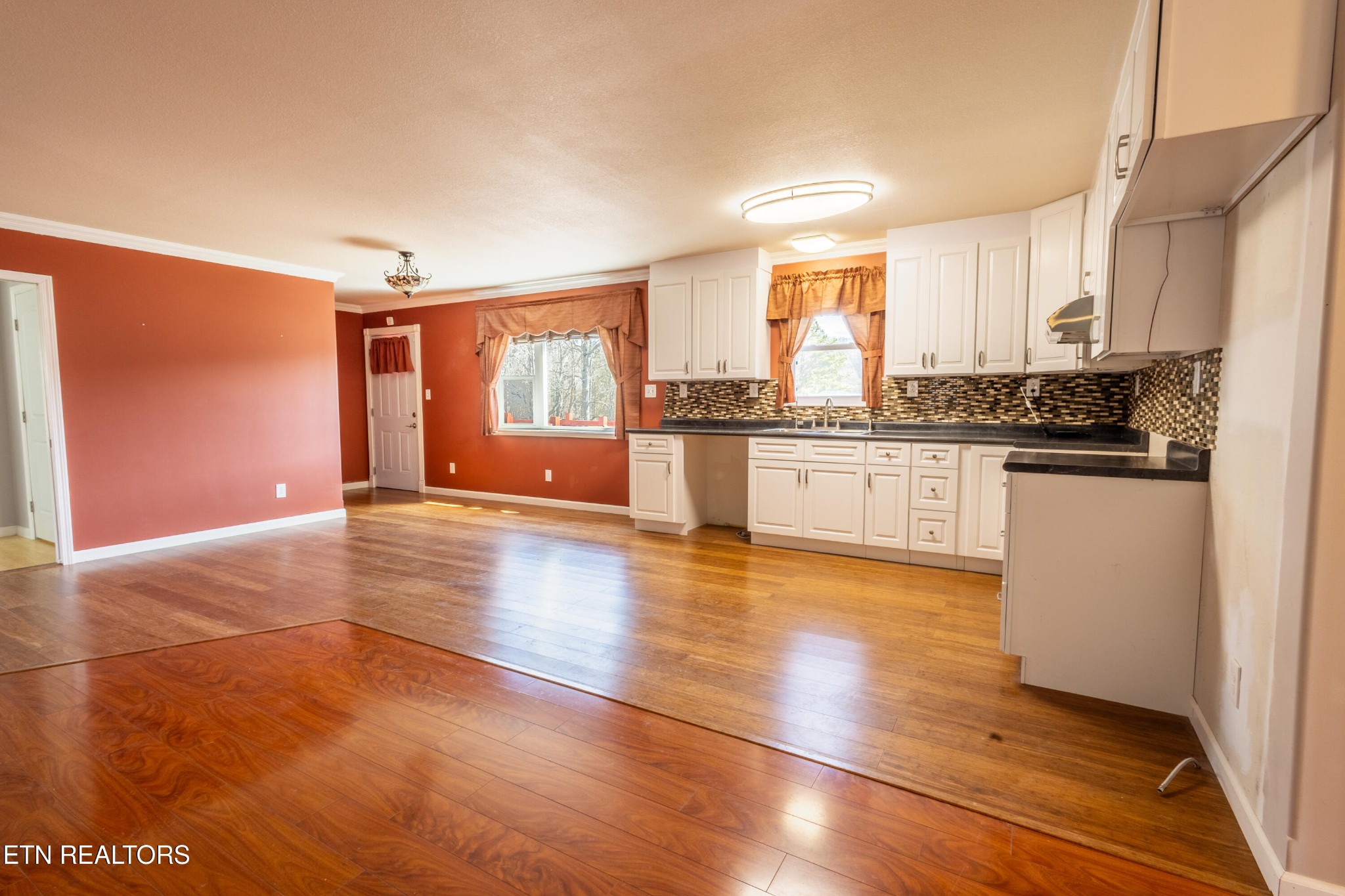 1208 Dutch Valley Road Clinton, TN 37716 - Photo 5 of 21 a view of a kitchen with kitchen island wooden floors and stainless steel appliances