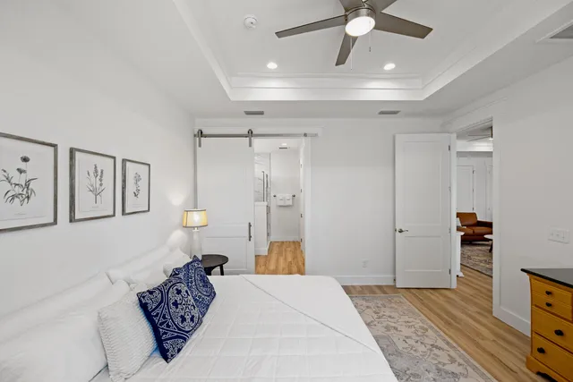 a spacious bedroom with a bed and a chandelier