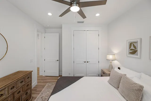 a bedroom with a bed and a chandelier