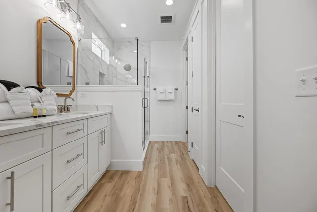 a spacious bathroom with a double vanity sink and a mirror