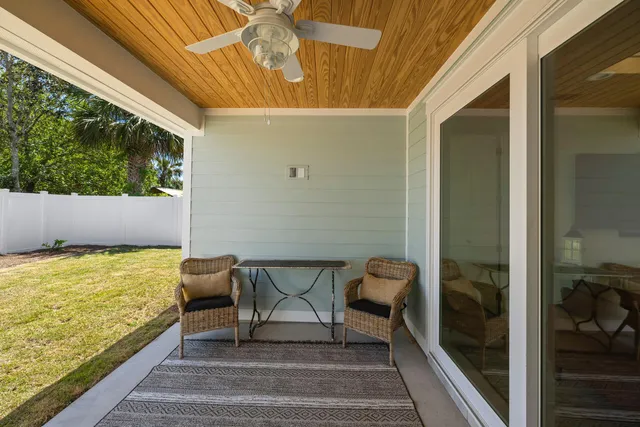 a view of a balcony with chair and floor to ceiling window