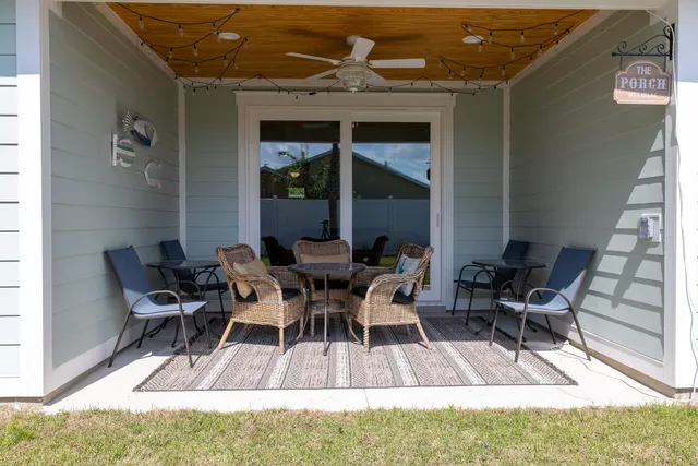 a view of a patio with table and chairs and potted plants