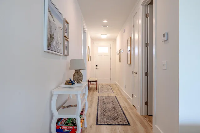 a hallway with a view of bathroom