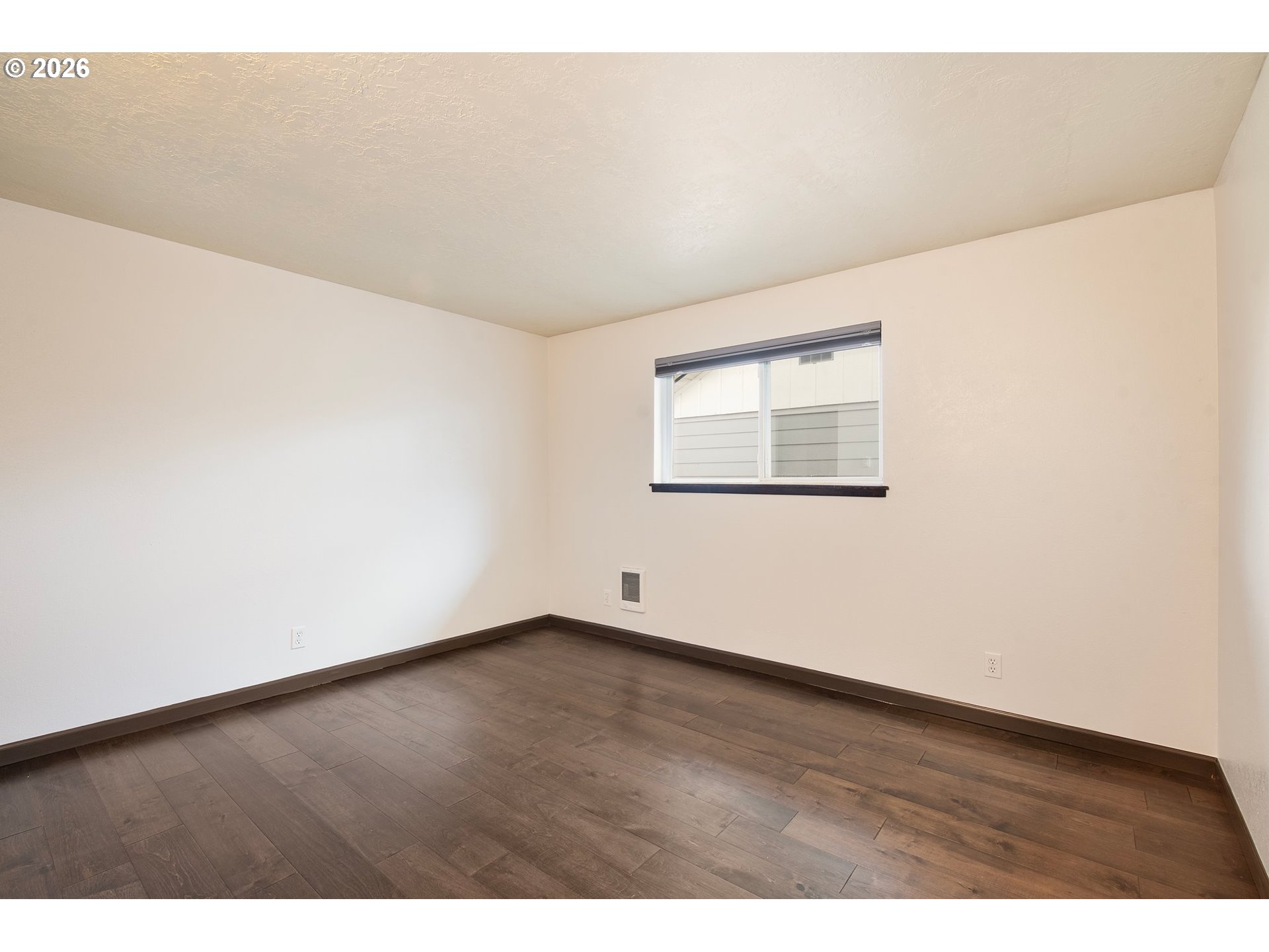 58015 Godley Road Union, OR 97883 - Photo 18 of 44 an empty room with wooden floor and windows