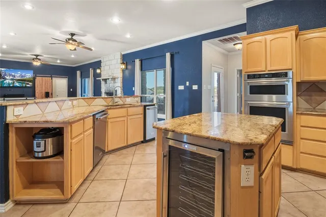 a kitchen with stainless steel appliances granite countertop a sink and cabinets