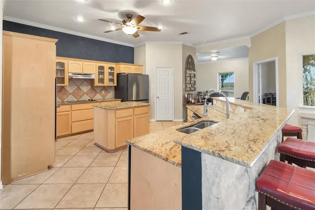 a kitchen with a stove a sink and a refrigerator