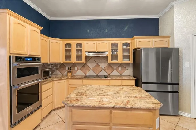 a kitchen with a stove a refrigerator and a sink