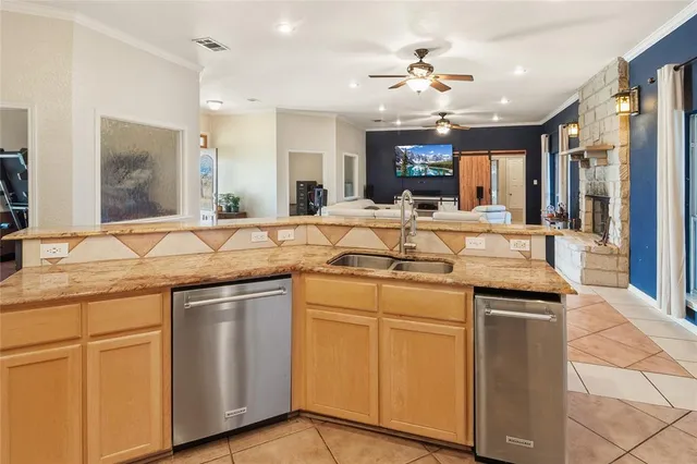 a kitchen with center island and stainless steel appliances