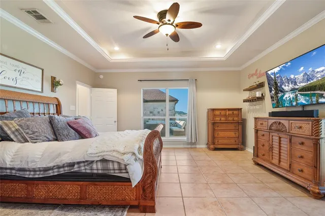 a bedroom with a bed and dresser with mirror