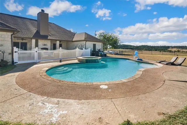 a front view of a house with swimming pool yard and outdoor seating