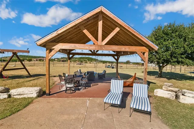 a view of a house with swimming pool and sitting area