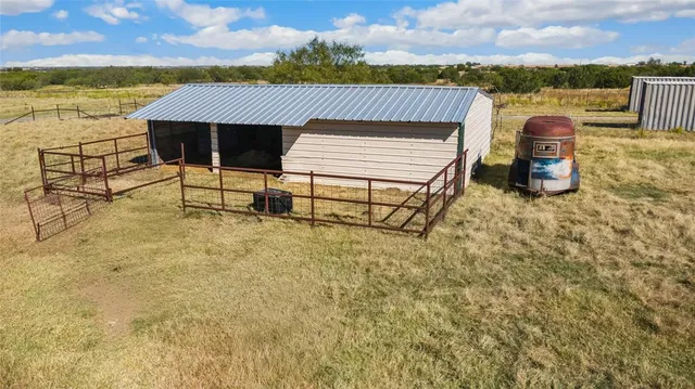 an aerial view of a house with swimming pool and outdoor seating