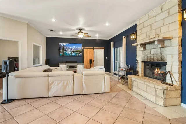 a living room with furniture a fireplace and a flat screen tv