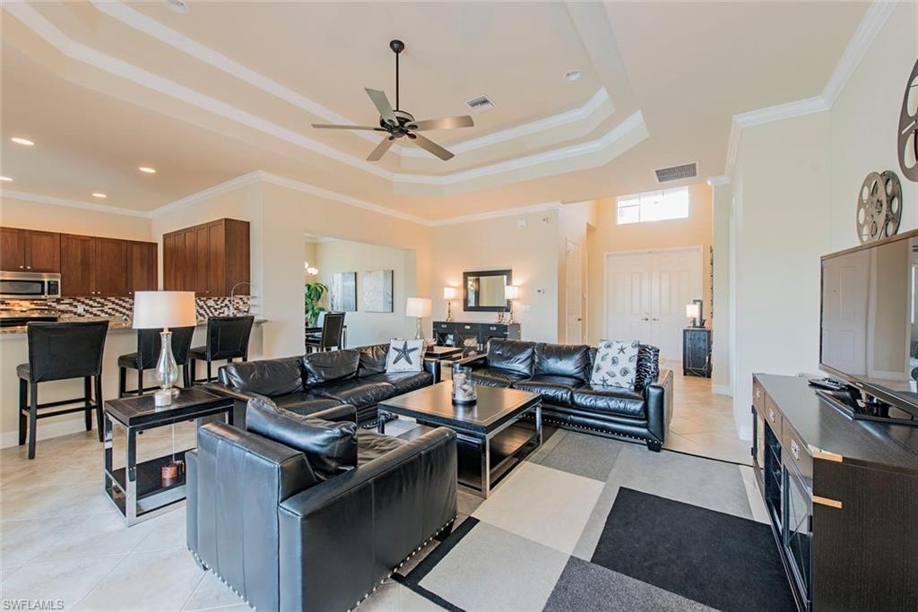 6559 Monterey Point Naples, FL 34105 - Photo 2 of 12 a living room with furniture and a flat screen tv