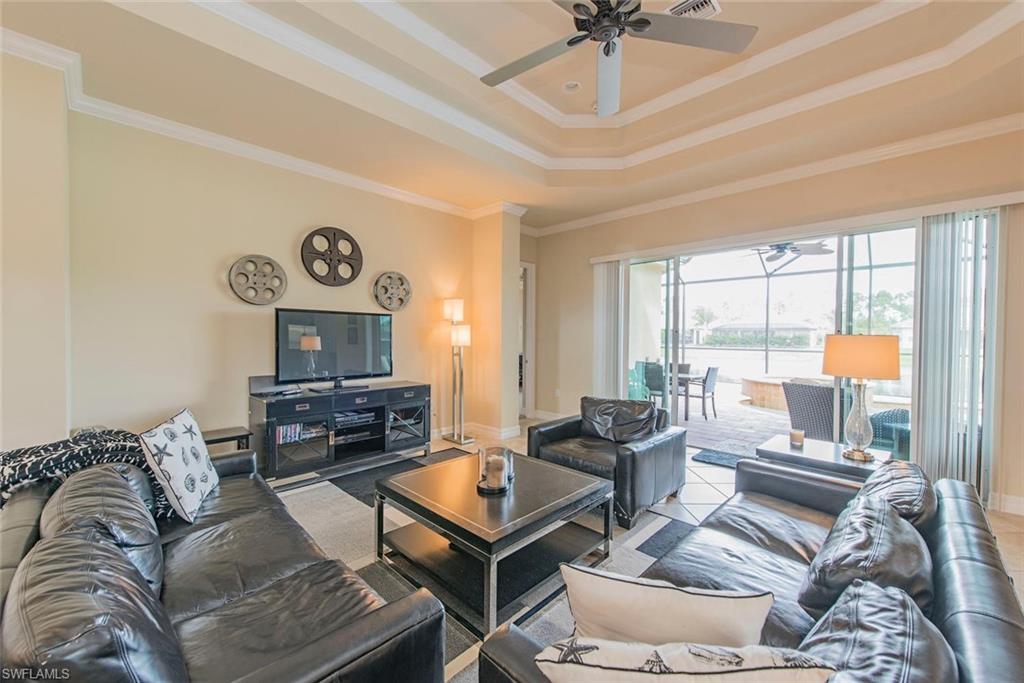 6559 Monterey Point Naples, FL 34105 - Photo 3 of 12 a living room with furniture a flat screen tv and a large window