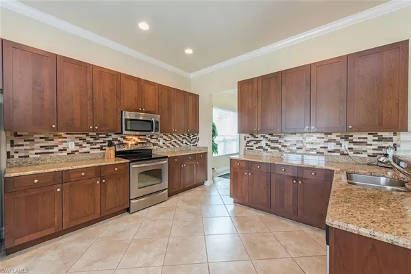 a kitchen with stainless steel appliances granite countertop a stove microwave and cabinets