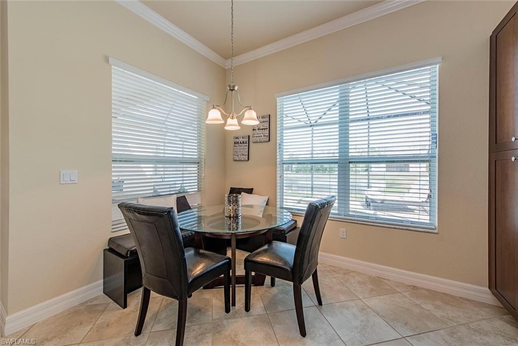 6559 Monterey Point Naples, FL 34105 - Photo 6 of 12 a view of a dining room with furniture and chandelier