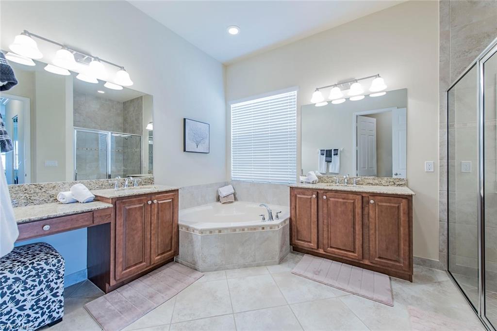6559 Monterey Point Naples, FL 34105 - Photo 8 of 12 a spacious bathroom with a tub sink and mirror