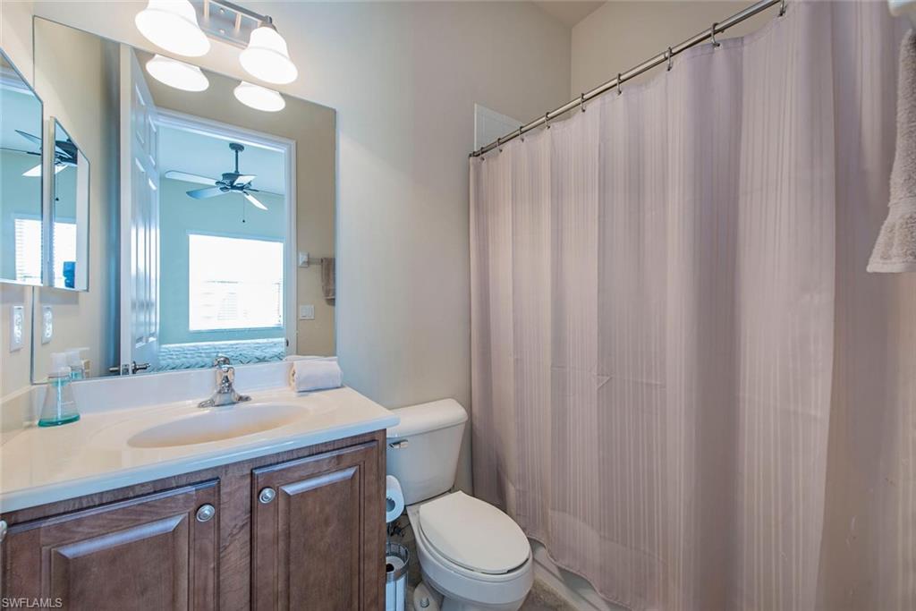 6559 Monterey Point Naples, FL 34105 - Photo 10 of 12 a bathroom with a granite countertop sink toilet and a mirror