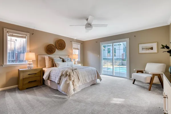 a bedroom with a bed chair and window