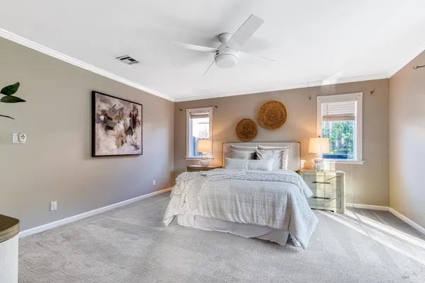 a bedroom with a large bed and a window