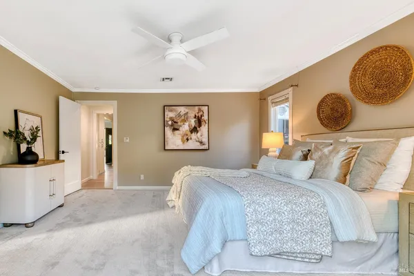 a bedroom with a large bed and a chandelier