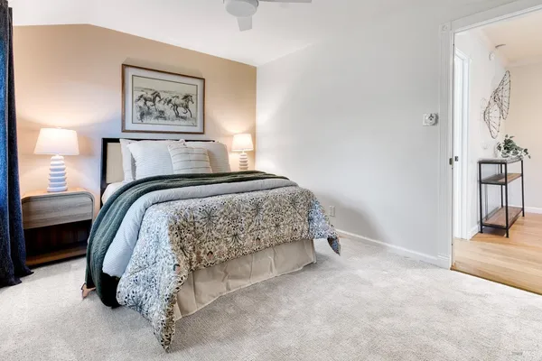 a bedroom with a bed and a painting on the wall