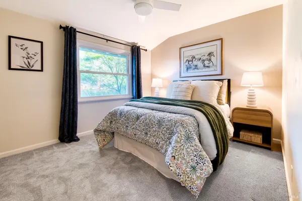 a bed sitting in a bedroom next to a window