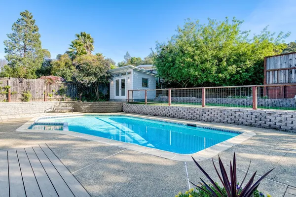 a view of a house with backyard and sitting area