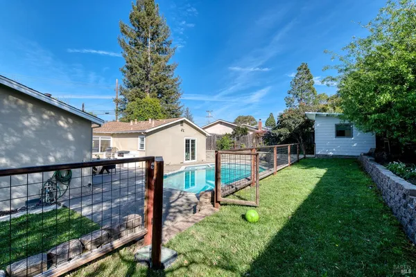 a swimming pool with yard in front of it