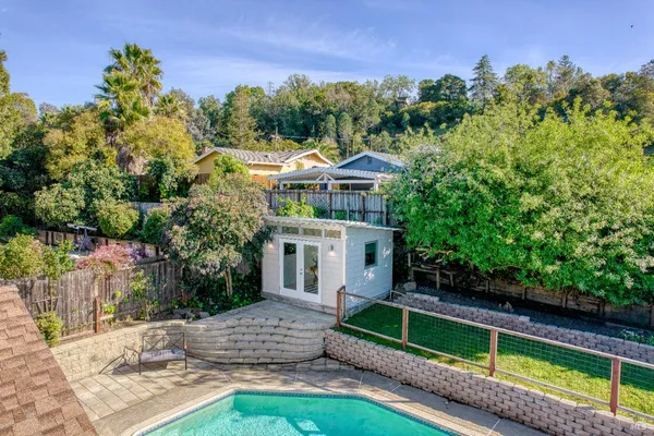 a house view with swimming pool and sitting space