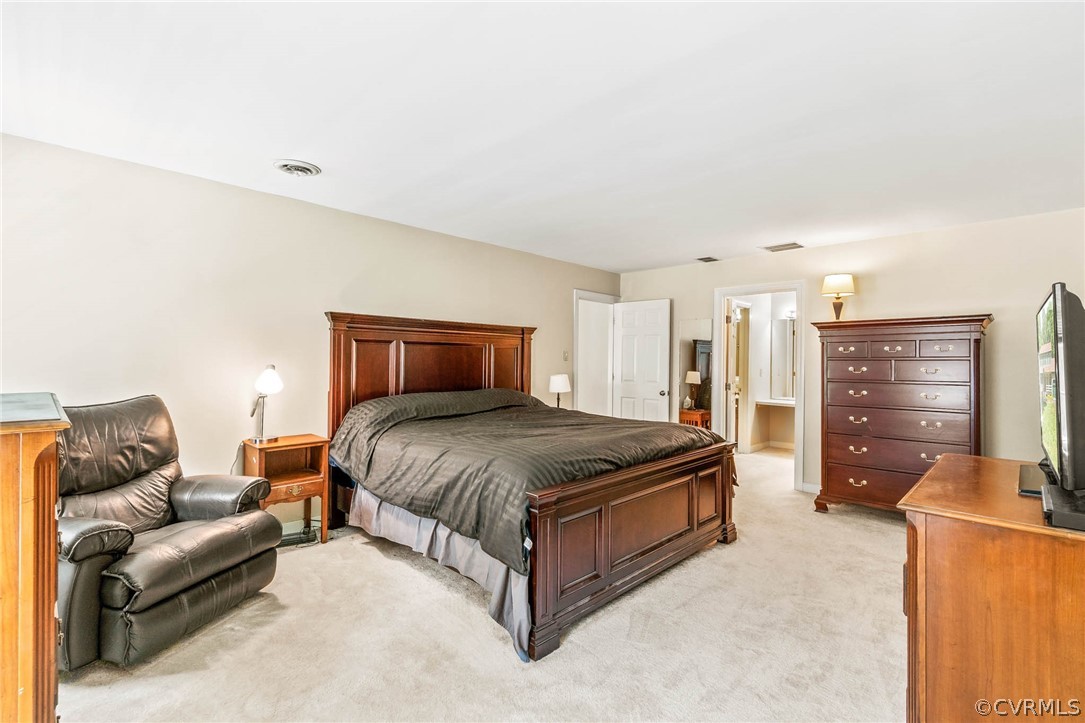 2801 Fairgate Road Midlothian, VA 23112 - Photo 27 of 49 a spacious bedroom with a bed and a couch