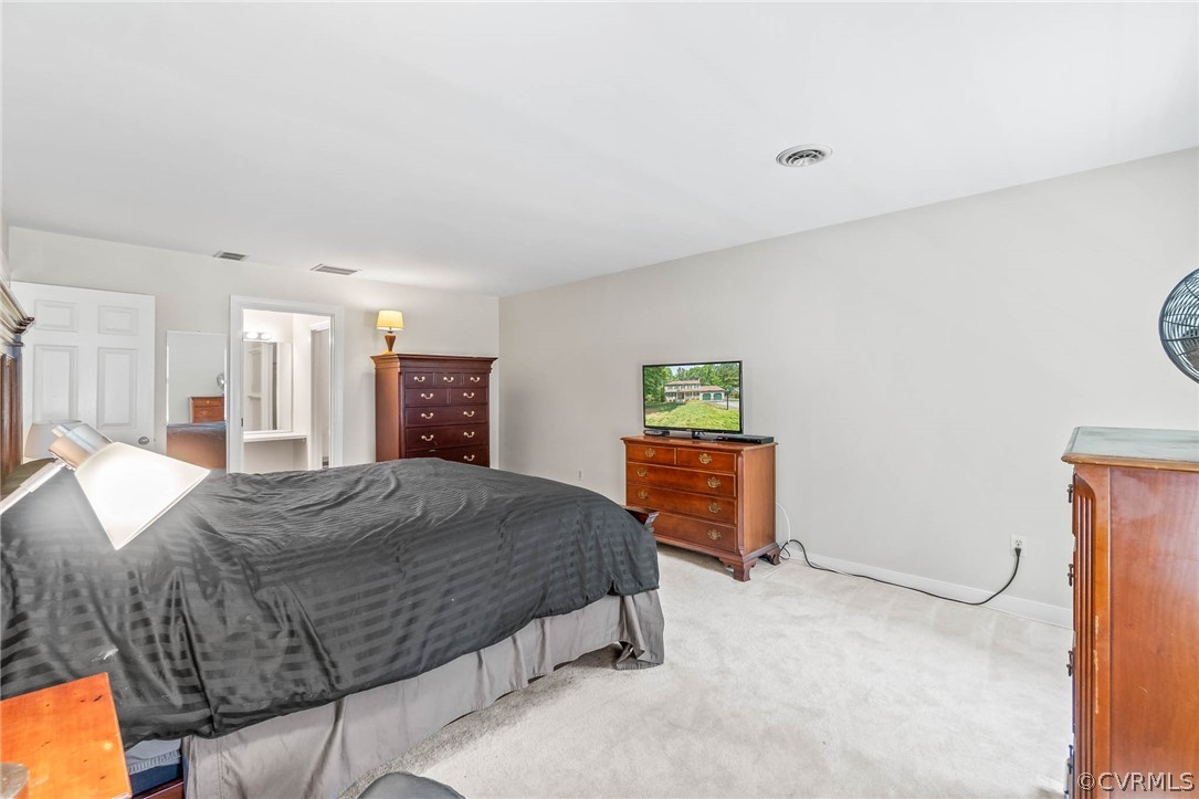 2801 Fairgate Road Midlothian, VA 23112 - Photo 30 of 49 a spacious bedroom with a bed and a cabinets