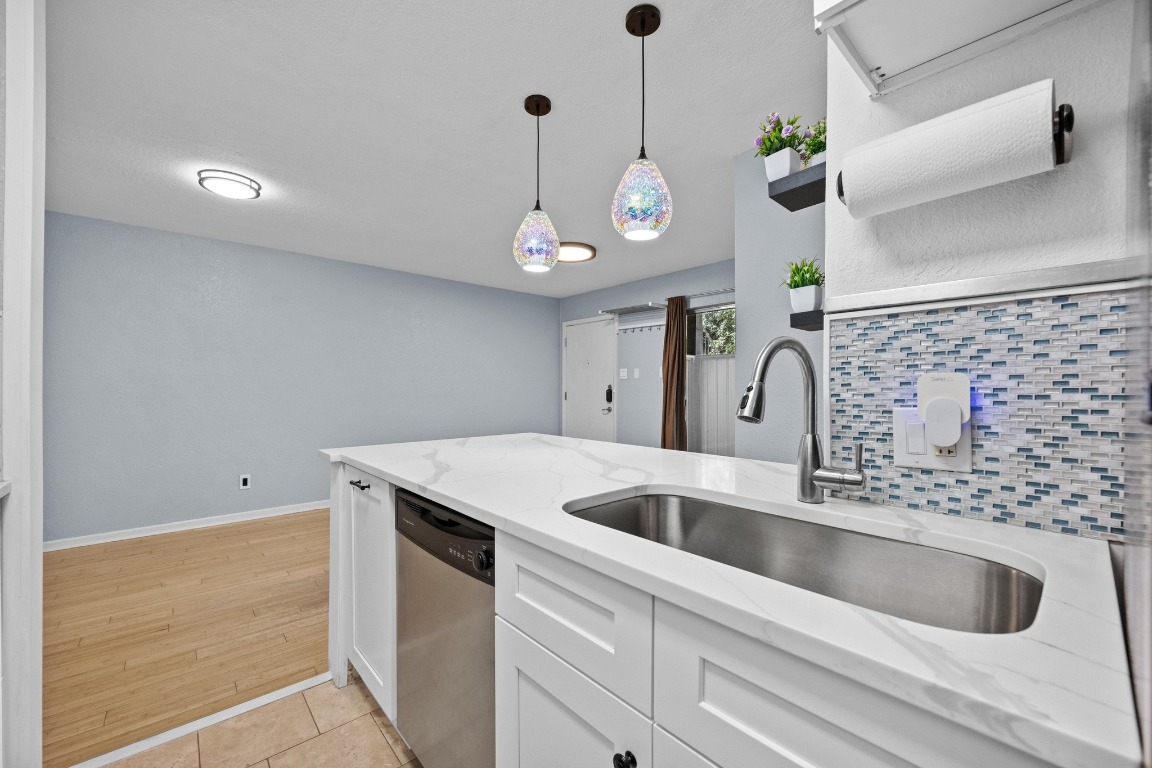 3204 Menchaca Road, Unit 405 Austin, TX 78704 - Photo 3 of 29 a kitchen with a sink and chandelier