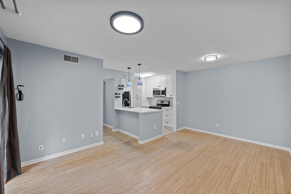 3204 Menchaca Road, Unit 405 Austin, TX 78704 - Photo 6 of 29 a view of kitchen with wooden floor