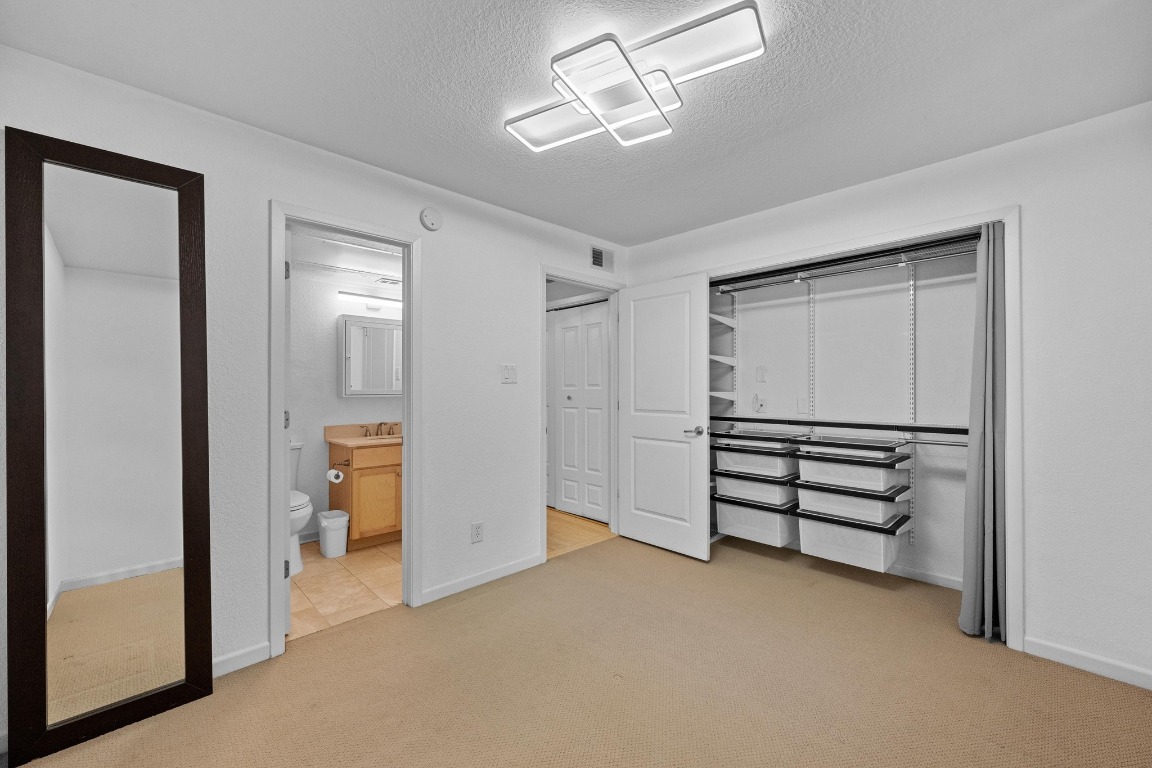 3204 Menchaca Road, Unit 405 Austin, TX 78704 - Photo 8 of 29 a view of empty room with closet and fan