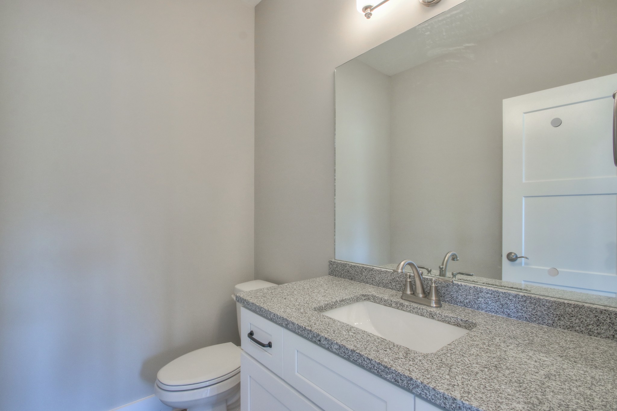 2595 Tracy Road Watertown, TN 37184 - Photo 15 of 45 a bathroom with a granite countertop toilet sink mirror and vanity