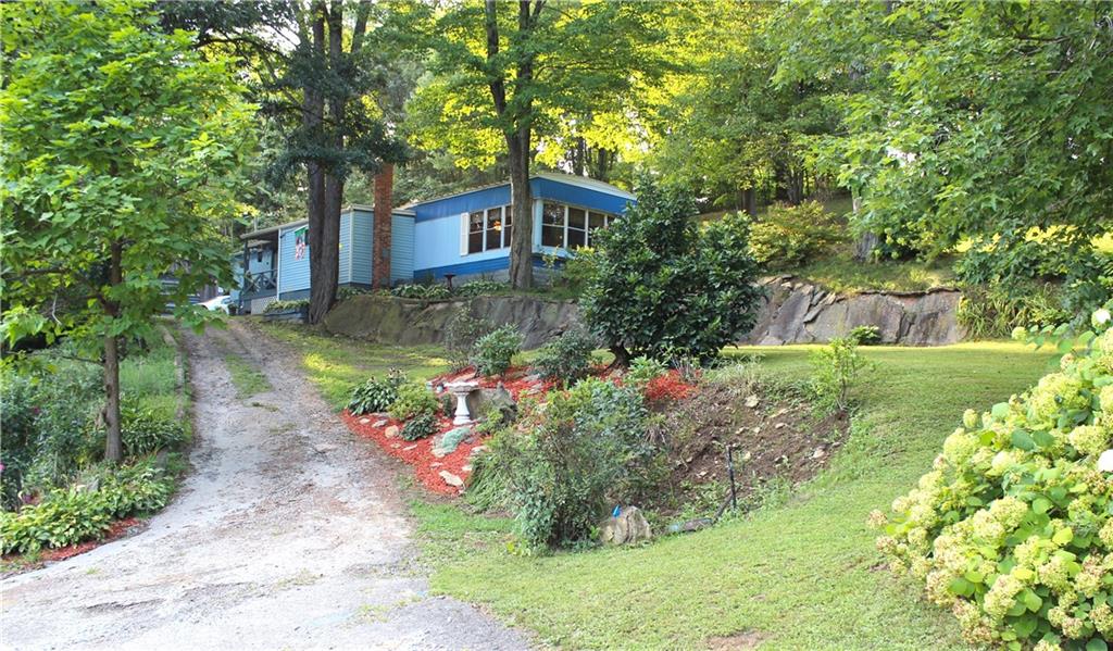 Nestled on a beautiful acreage this home enjoys woodlands, wildlife and privacy. Minutes to I76.