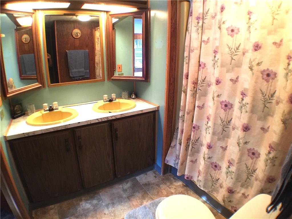 149 Fry Hollow Road Hunker, PA 15639 - Photo 19 of 22 Master bedroom full bathroom. Dual sinks & vanity mirrors, tub/shower combo, toilet and vinyl flooring. Bathroom can also be accessed from main hallway.