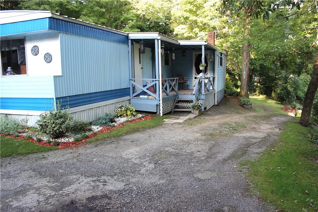 Private drives leads to home and 3 car garage. Enjoy privacy on the Front Porch that overlooks the hillside valley. 