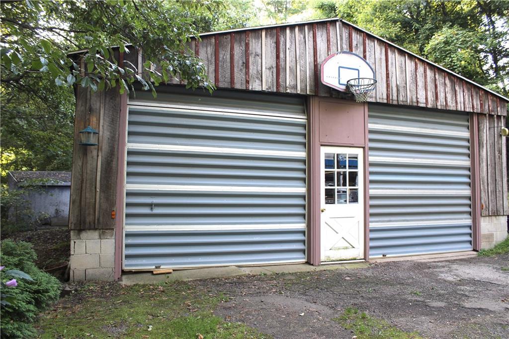 149 Fry Hollow Road Hunker, PA 15639 - Photo 8 of 22 THREE car garage (tandem & single space) + LARGE workshop room and Man Door. DIMS are 37'x28'x14'. Perfect for the person who loves to tinker or work hard in the garage.