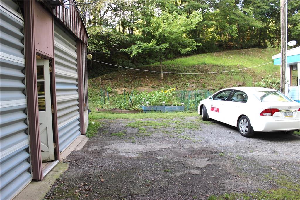 149 Fry Hollow Road Hunker, PA 15639 - Photo 9 of 22 Side drive area can park two additional vehicles while allowing complete access to the garage doors. There's ADDITIONAL parking on the lower area of the driveway for TWO ADDITIONAL vehicles. 3 + 2 + 2 = 7 vehicle parking.